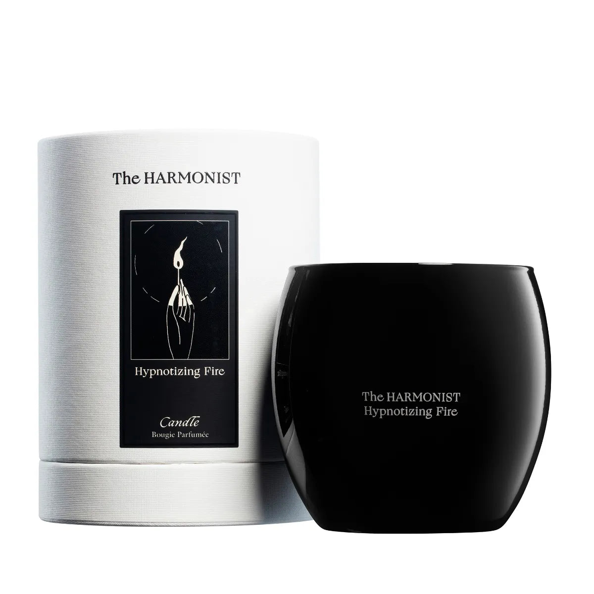 The Harmonist Hypnotizing Fire candle with black glass container and white cylindrical packaging.