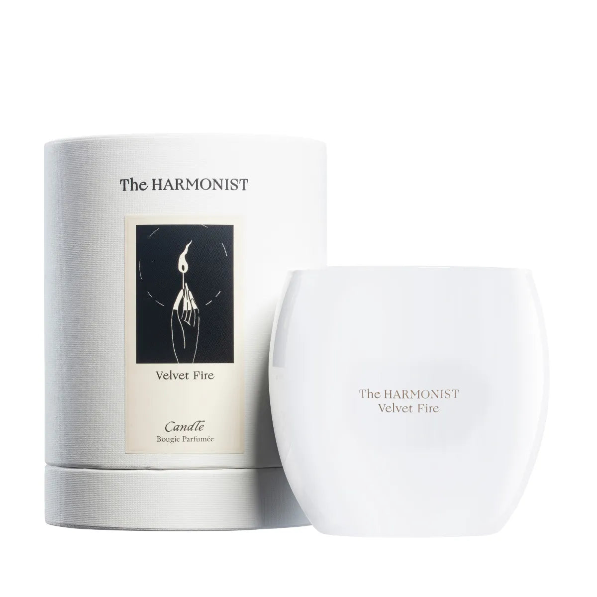 The Harmonist Velvet Fire candle with white glass container and matching cylindrical packaging.